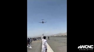 Dramatic video at Kabul airport as Afghans try to flee rush plane on runway [upl. by Eedolem]